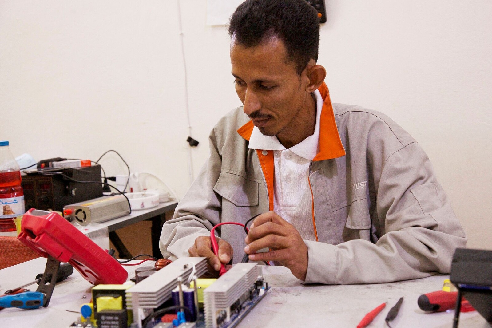 Ein junger Mann repariert Solarpanels für nachhaltige Hilfe