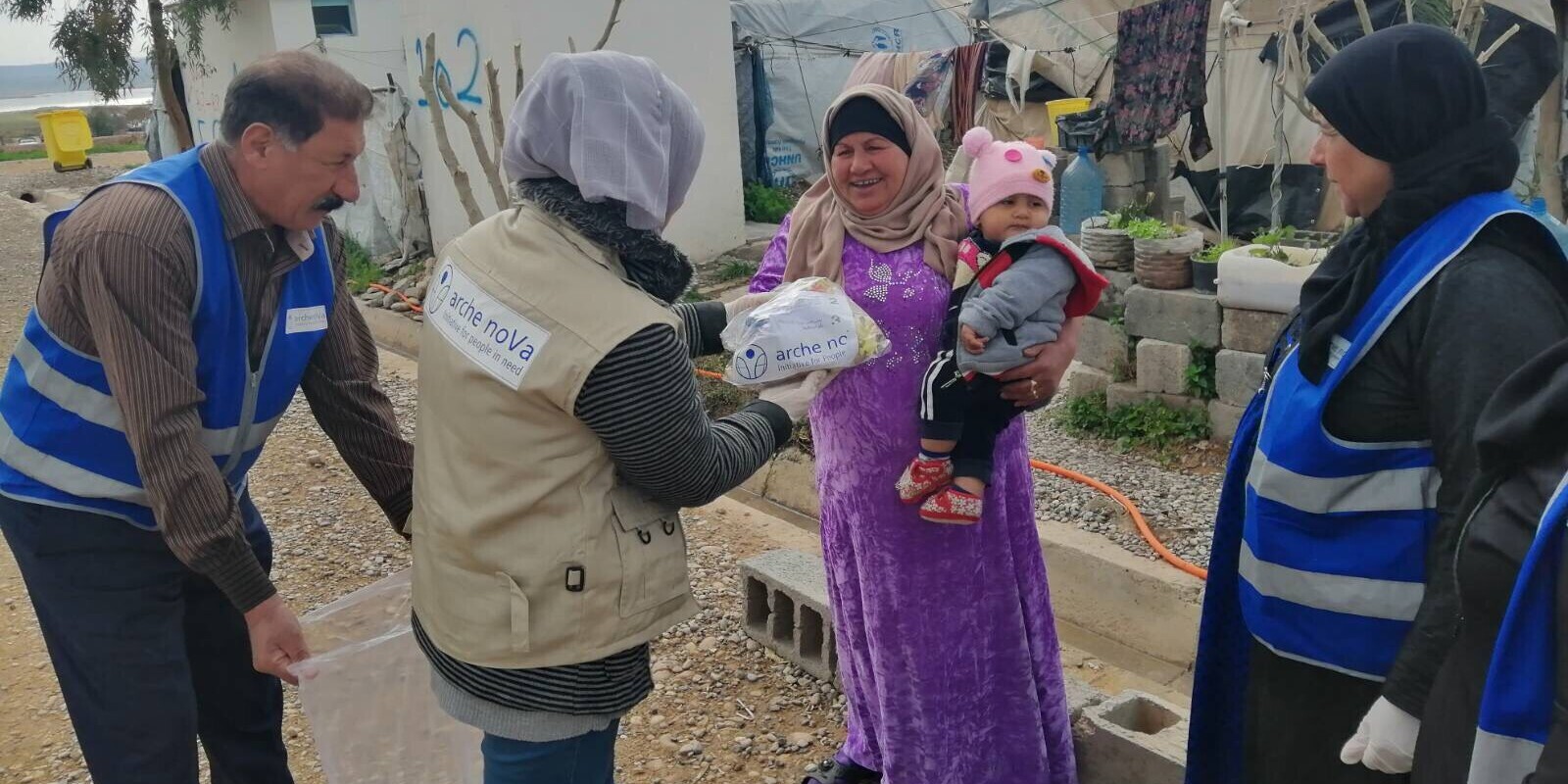 Helfer und Helferinnen von arche noVa verteilen in einem Flüchtlingscamp im Irak Hilfsgüter Helfer und Helferinnen von arche noVa verteilen in einem Flüchtlingscamp im Irak Hilfsgüter
