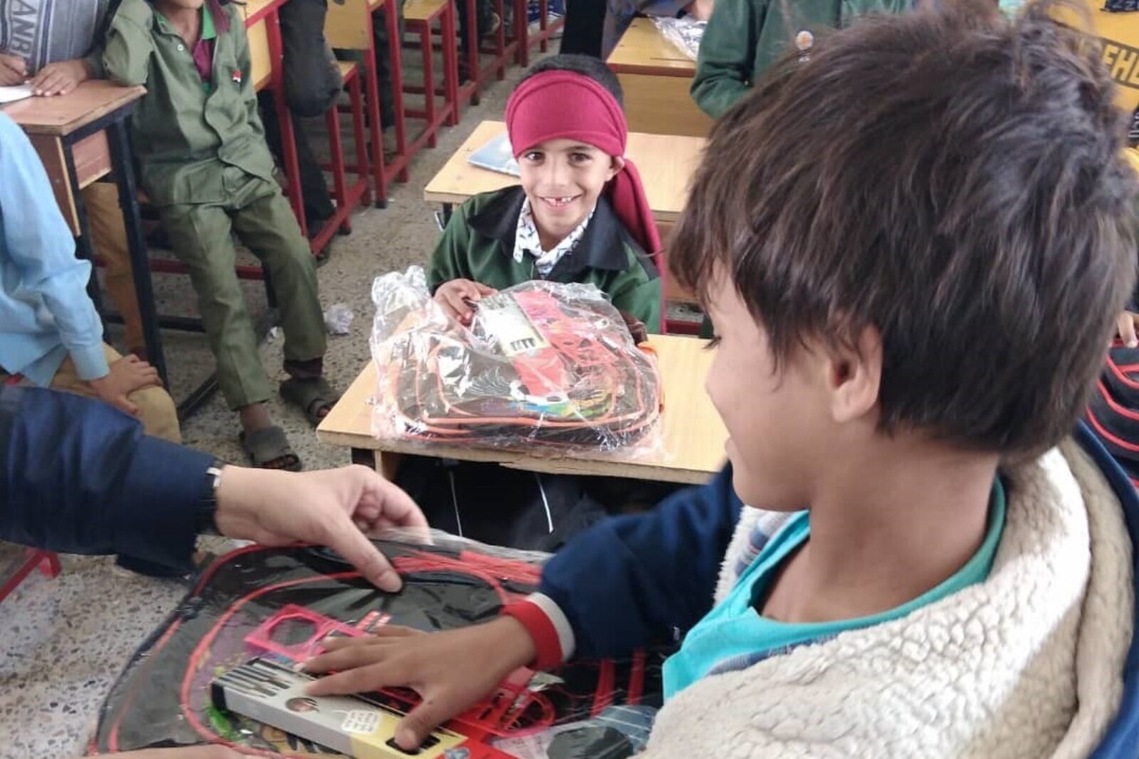 In einer Schule im Jemen erhalten Kinder Stifte und Ranzen