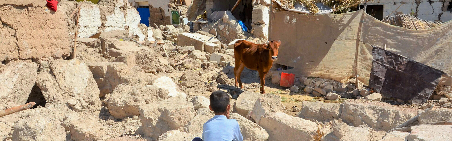 Ein Junge sitzt nach dem Erdbeben in Marokko auf Trümmern Ein Junge sitzt nach dem Erdbeben in Marokko auf Trümmern