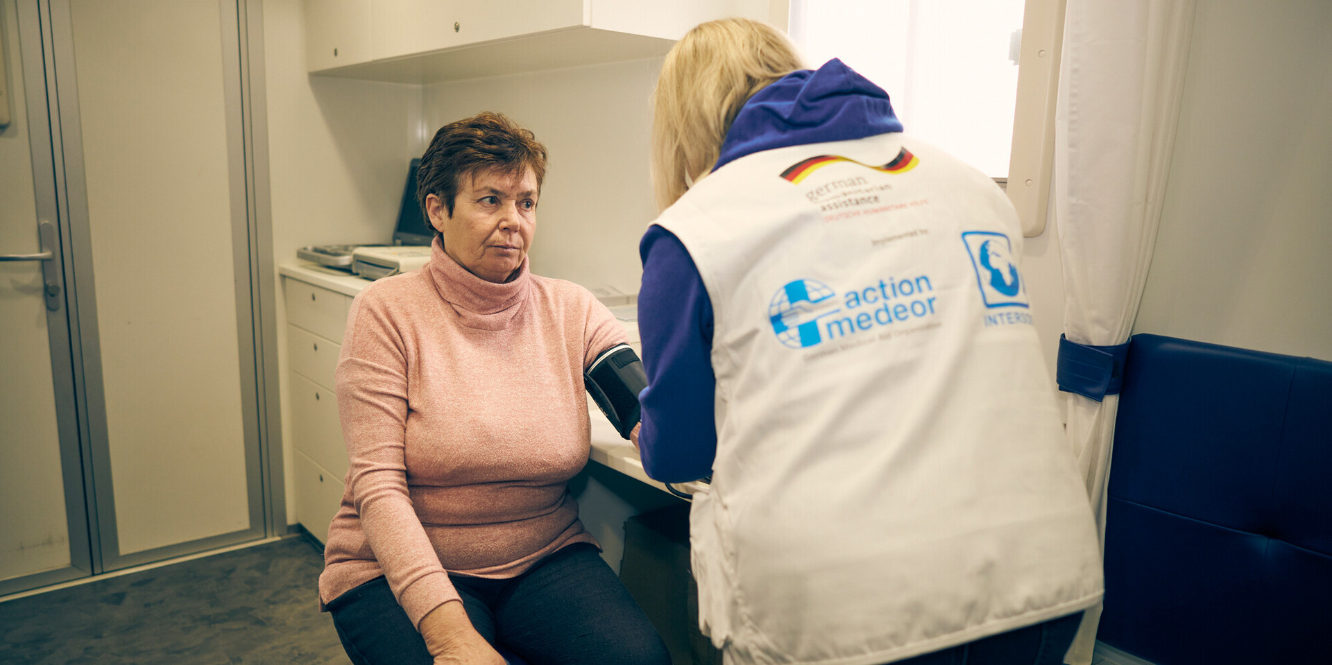 Nadia lässt sich von einer Ärztin den Blutdruck messen Nadia lässt sich von einer Ärztin den Blutdruck messen