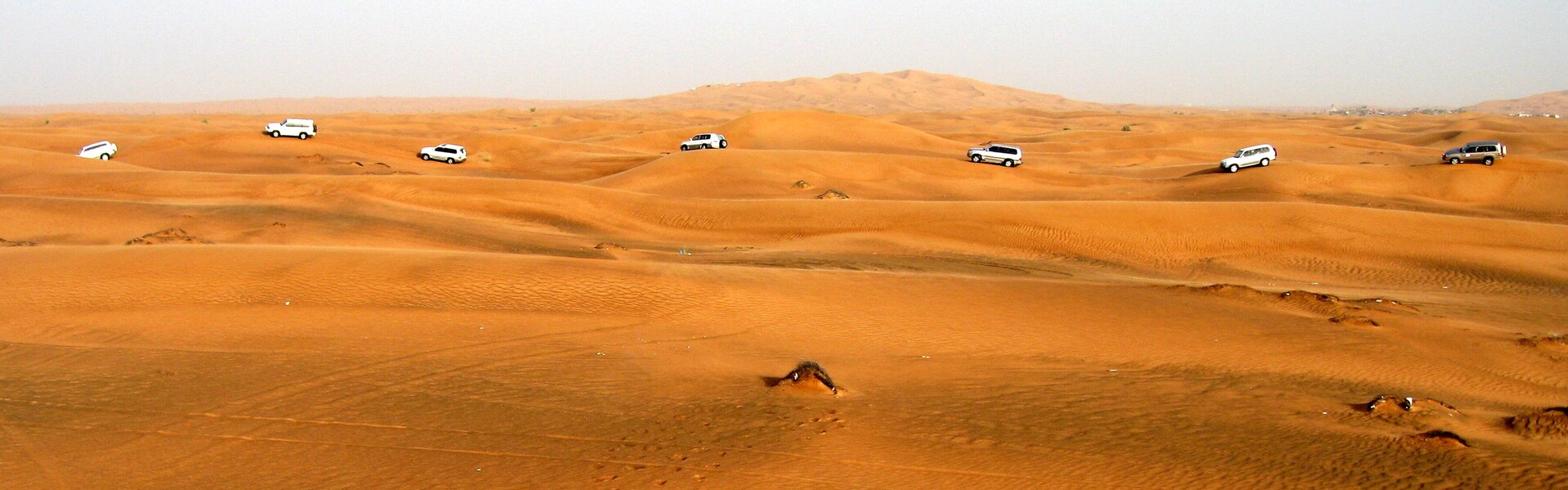 Autos fahren durch die Wüste in den Vereinigten Arabischen Emiraten Autos fahren durch die Wüste in den Vereinigten Arabischen Emiraten